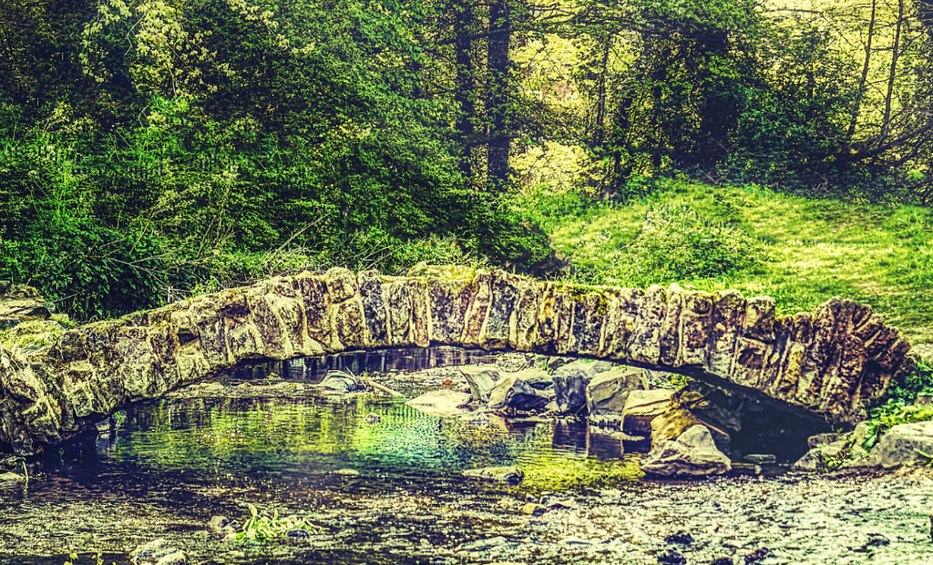 a strong stone bridge across a river