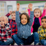 a group of diverse children holding hands and dancing and singing in a circle