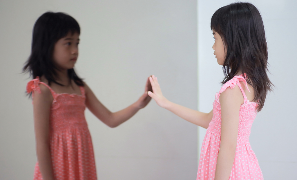 a group of diverse children holding hands and dancing and singing in a circle