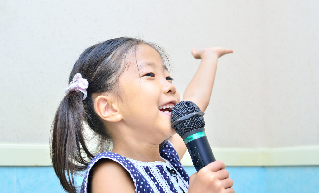 a group of diverse children holding hands and dancing and singing in a circle