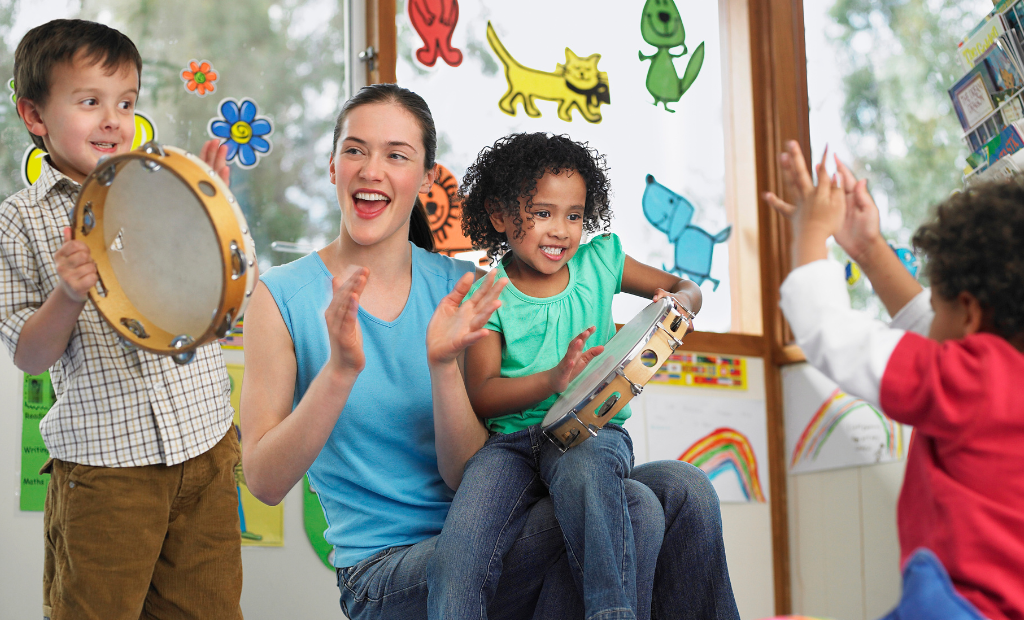 a group of diverse children holding hands and dancing and singing in a circle