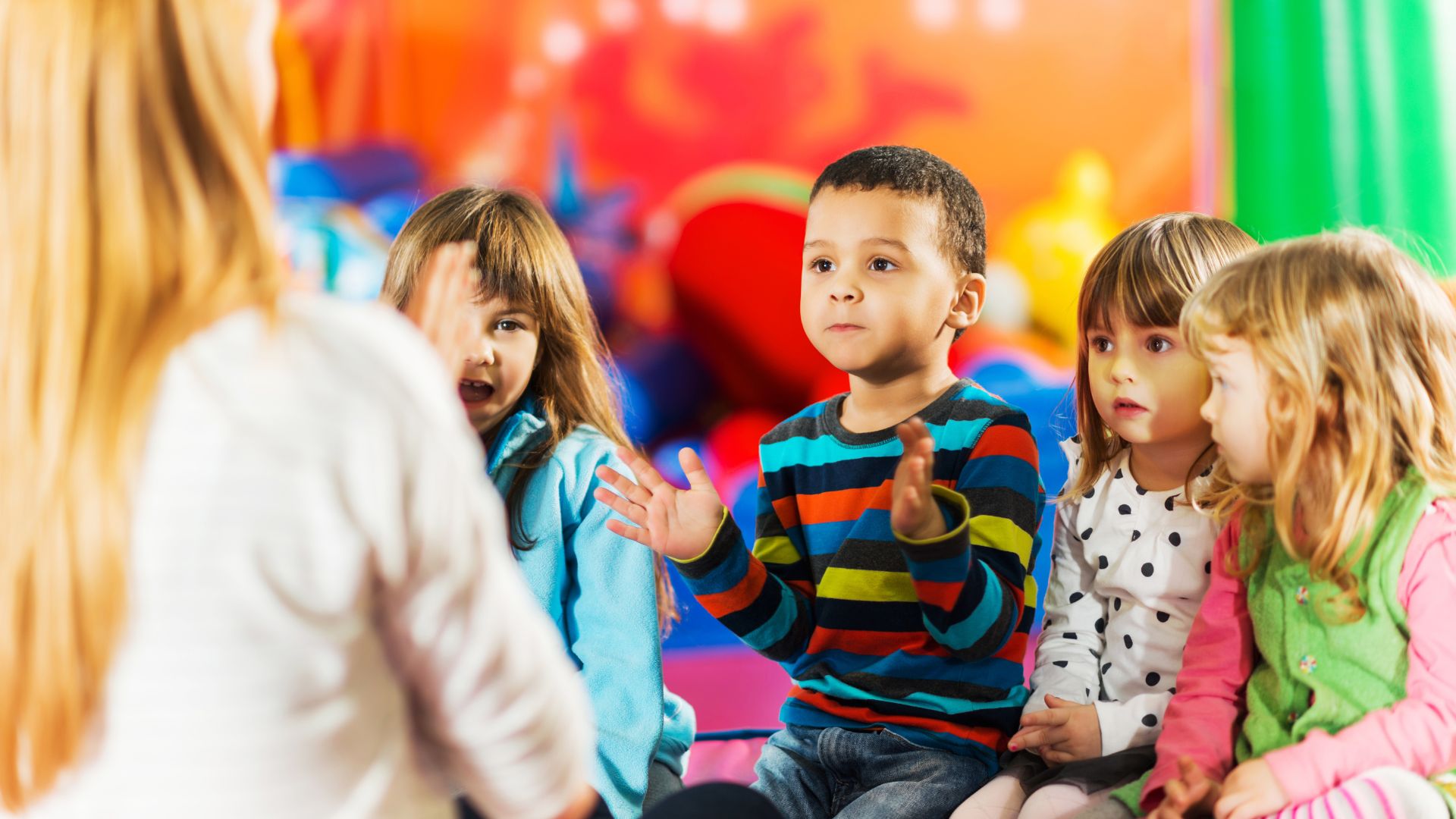 a group of diverse children holding hands and dancing and singing in a circle